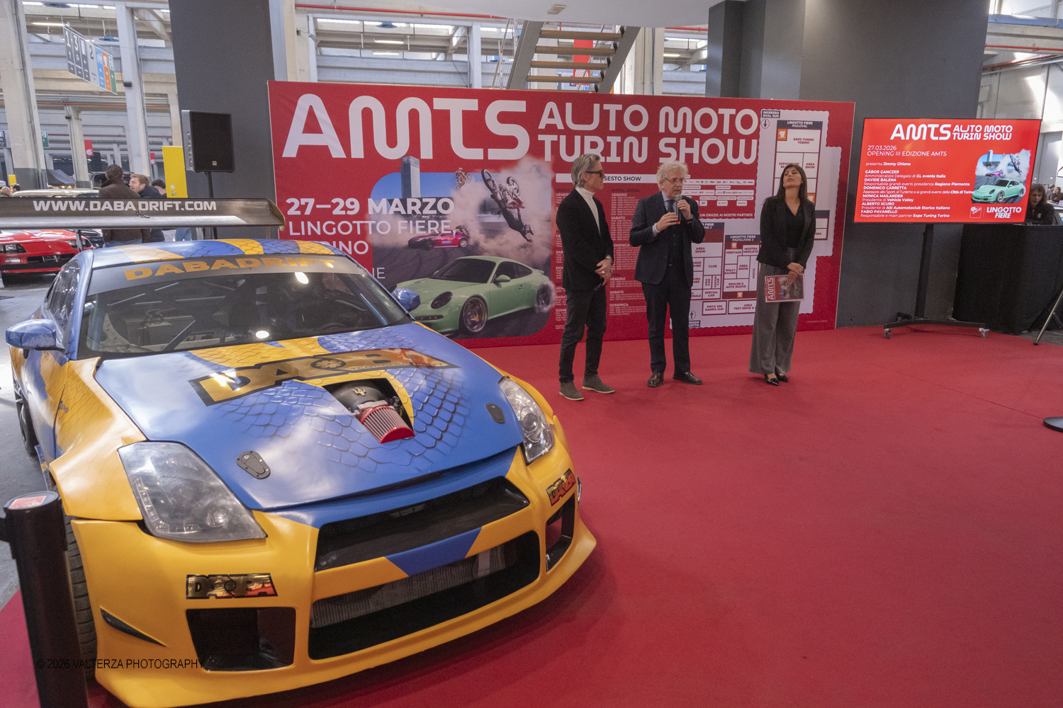 _DSF6982.jpg - 27/03/2026/. Torino.  Ad AMTS , Auto Moto Turin Show, lo spettacolo Ã¨ protagonista per tutto il weekend! 3 arene indoor e 2 piste outdoor dedicate agli show. Spettacoli di freestyle, drifting e stunt con piloti e rider professionisti. Nella foto  Jimmy Ghione di Striscia la Notizia apre l'inaugurazione della mostra con le interviste a Gabor Gangzer AD di GL  events Italia, Davide Balena responsabile grandi eventi Regione Piemonte, Domenico Carretta Assesssore Grandi eventi cittÃ  di Torino, Monica MailanderPresidente Vehicle Vallry, Alberto Scuro Presidente ASI, Fabio Pavanello Expo Tuning Torino   partecipanti al taglio del nastro