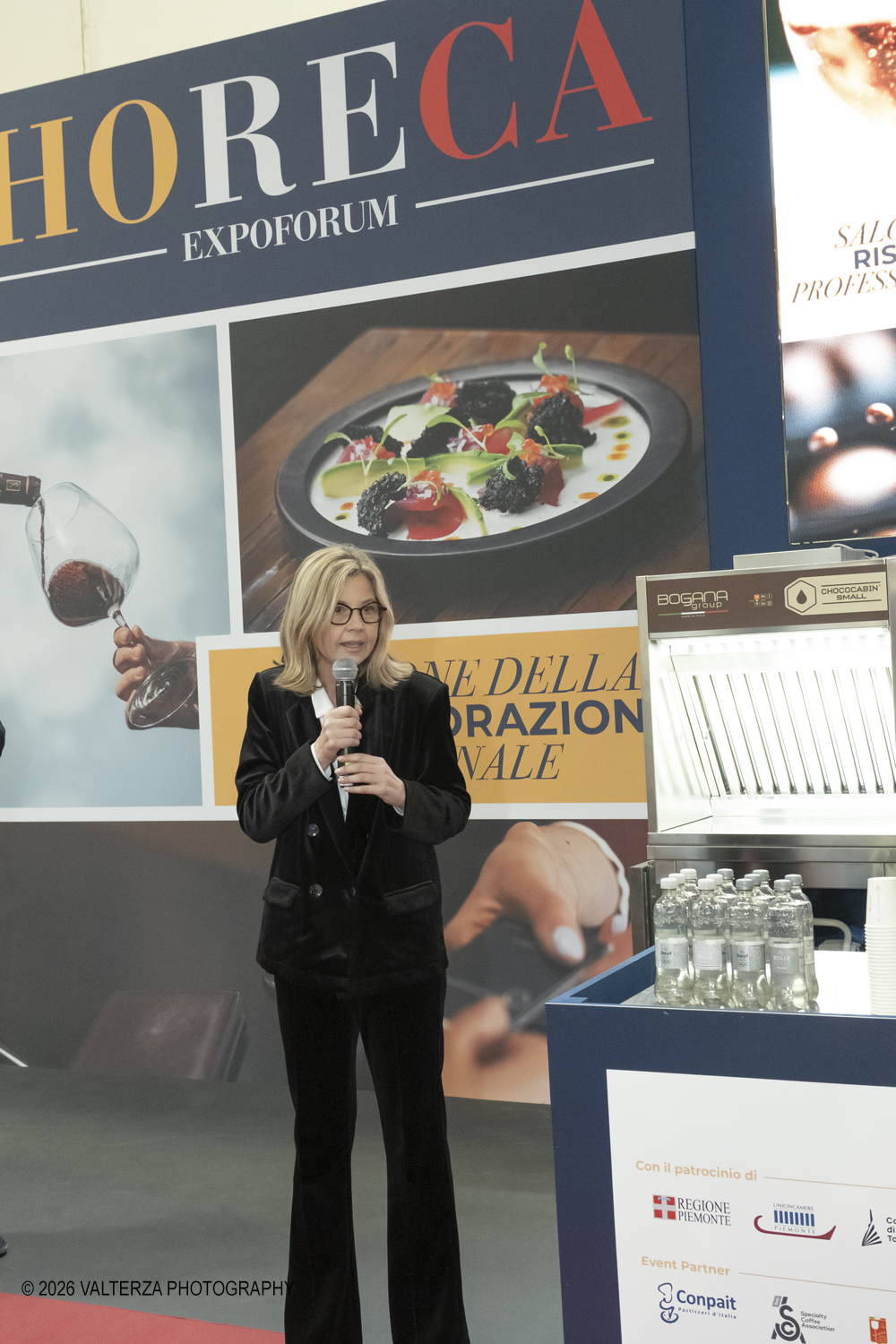 DSCF3371.jpg - 15/03/2026. Torino. Nel Padiglione 3 del Lingotto Fiere di Torino si svolge la terza edizione di Horeca Expoforum. Con oltre 300 brand italiani e internazionali presenti e circa 100 eventi in tre giorni, Horeca Expoforum si conferma piattaforma di riferimento per ristorazione, hotellerie e food service, punto di incontro fra innovazione, formazione e networking. Al centro dellâ€™inaugurazione il tema dello spreco alimentare. Nella foto l'intervento di  Maria Chiara Gadda, vicepresidente della commissione Agricoltura e prima firmataria della Legge 166/16 c.d. antispreco