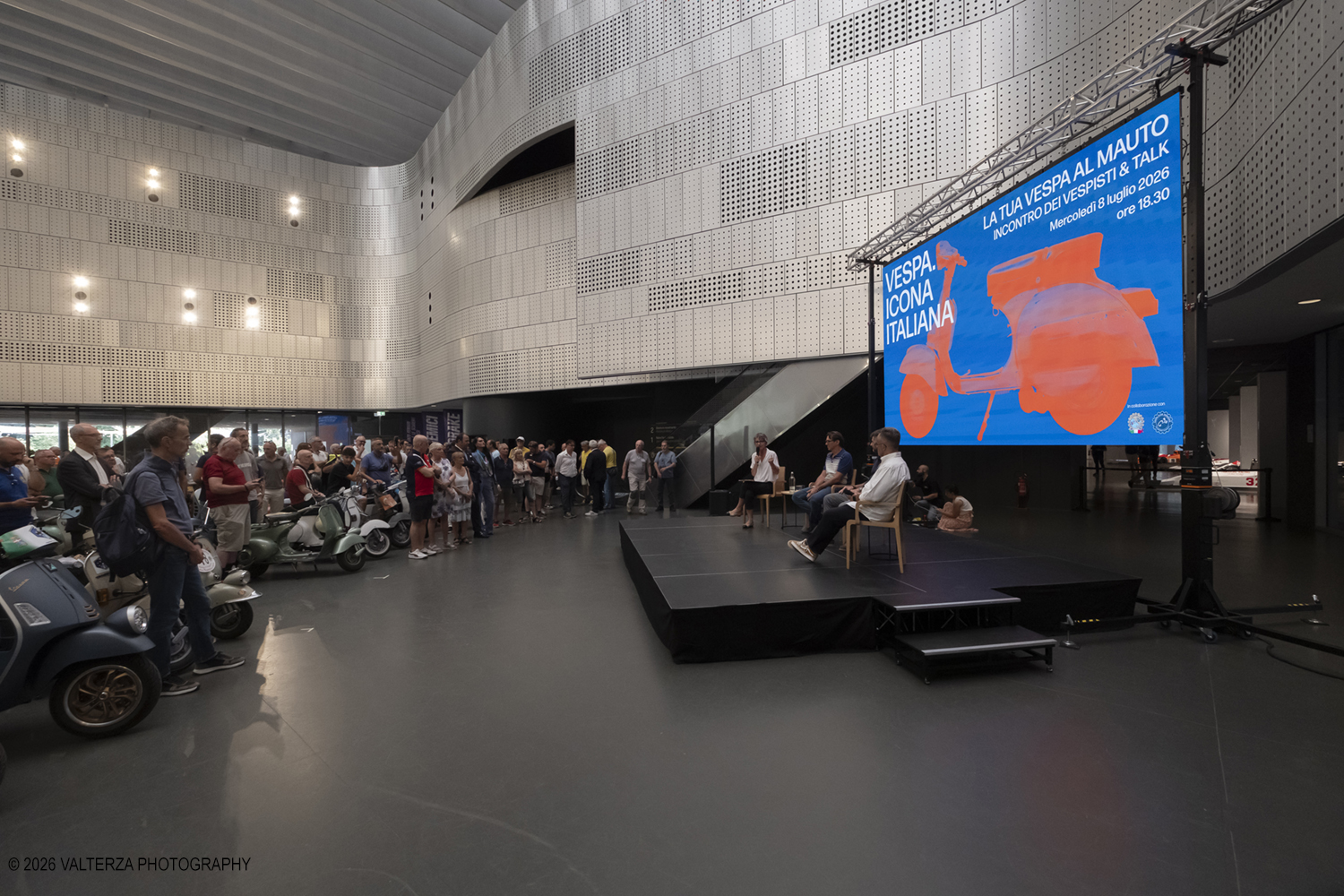 _DSF7845.jpg - 08/07/2026. Torino. In occasione della mostra VESPA. ICONA ITALIANA, il Museo Nazionale dellâ€™Automobile accoglie tutti i vespisti a vivere unâ€™esperienza esclusiva: per una sera la Piazza coperta del MAUTO ospita le Vespa dei partecipanti, che avranno lâ€™opportunitÃ  unica di esporre il proprio mezzo allâ€™interno del Museo, diventando protagonisti delle celebrazioni dedicate agli 80 anni di unâ€™autentica icona del design e della mobilitÃ  italiana. Nella foto un momento del Talk con Rino Drogo Curatore della mostra, Roberto Donati direttore storico culturale del Vespa Club dâ€™Italia, Marco Fumagalli collezionista titolare del materiale in mostra e imprenditore, Lorenza Bravetta Direttrice del MAUTO