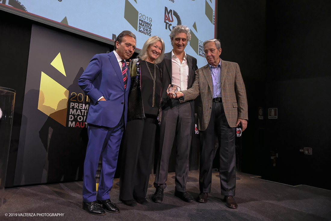 _DSF1580.jpg - 15/10/2019. Torino. Matita d'oro 2019. Anche quest'anno il Mauto ha assegnato i suoi prestigiosi premi al mondo dell'automobile. Nella foto Il premio MAUTO â€œCarlo Biscaretti di Ruffiaâ€� va allâ€™ Ing Mauro Forghieri  lâ€™insuperabile creativitÃ  ingegneristica e gli straordinari successi ottenuti su strada e su pista: durante gli anni in cui Ã¨ stato Direttore Tecnico della Scuderia Ferrari. Consegnano il premio  Mariella Mengozzi e Benedetto Camerana.