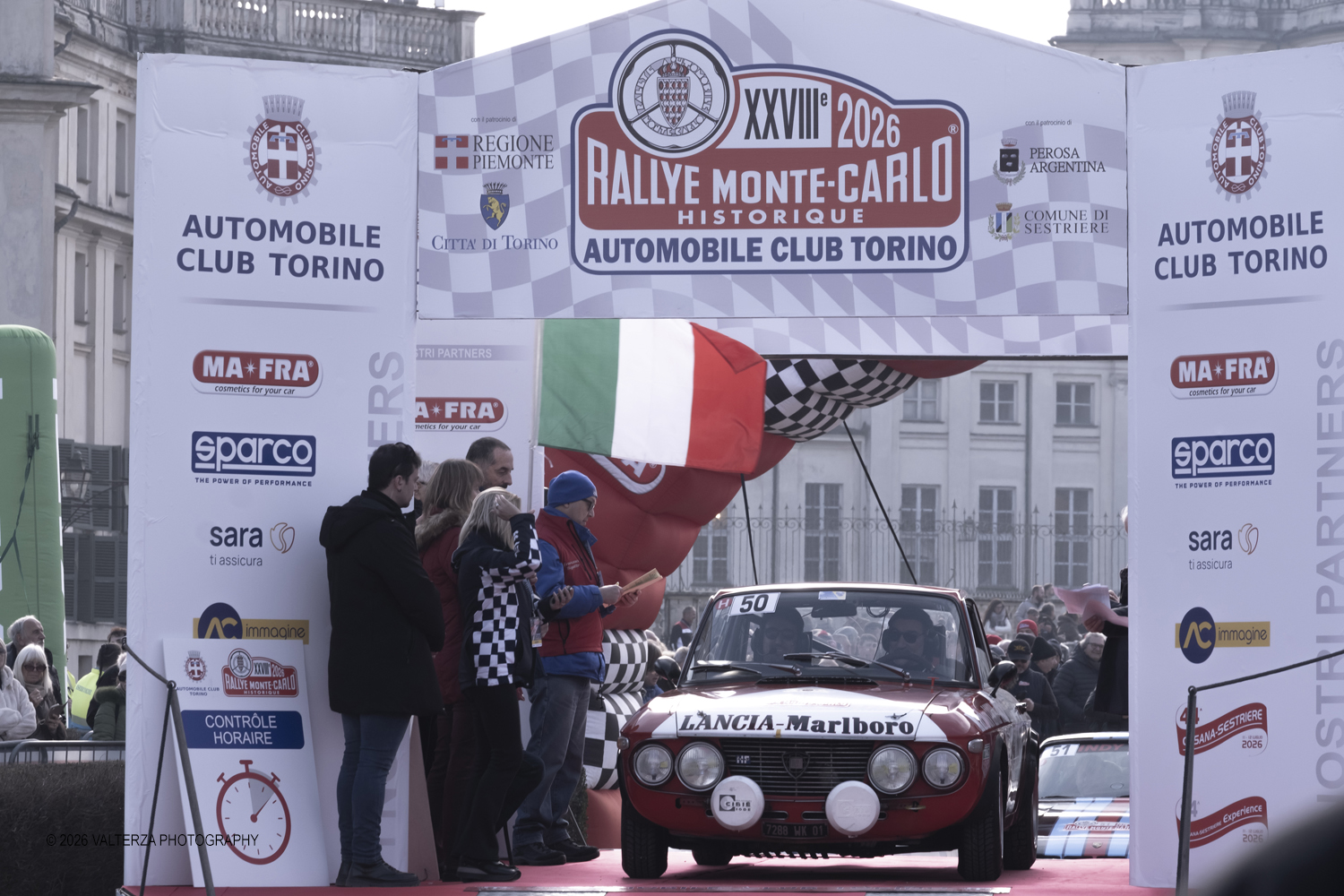 _DSF3935.jpg - La 28Âª edizione del Rallye Monte-Carlo Historique si svolge fino al 7 febbraio 2026 , ad eccezione della cittÃ  scozzese di  John O'Groats le varie cittÃ  di partenza hanno dato il via alla gara domenica 1 febbraio 2026. Tra queste anche Torino, la partenza Ã¨ avvenuta dalla Palazzina di caccia di Stupingi dove le vetture in gara hanno prima sostato in mostra nel parco partenze antistante la Palazzina. Nella foto vettura alla partenza ancia Fulvia HF 1.6 1969